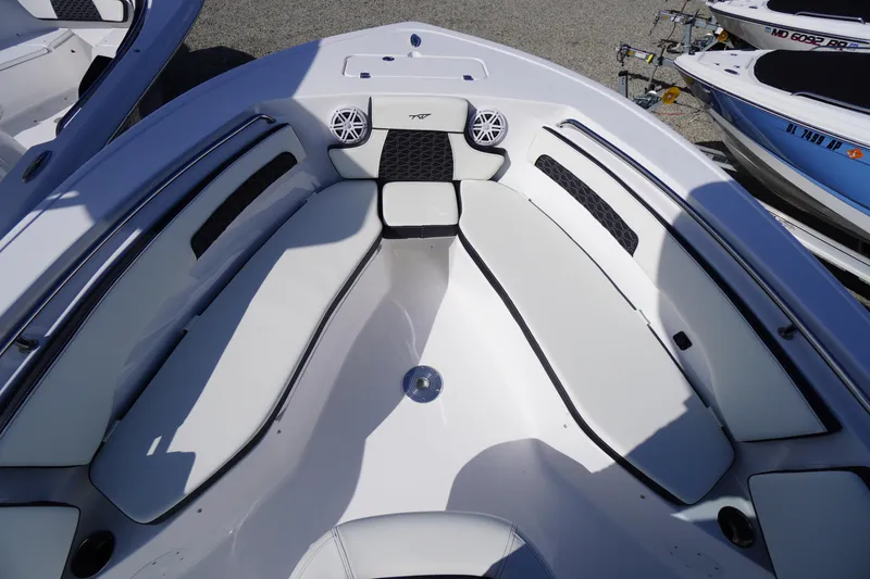Slide: The Image of 2026 Tidewater 220 LXF boat interior with white seating and speaker system. - 8