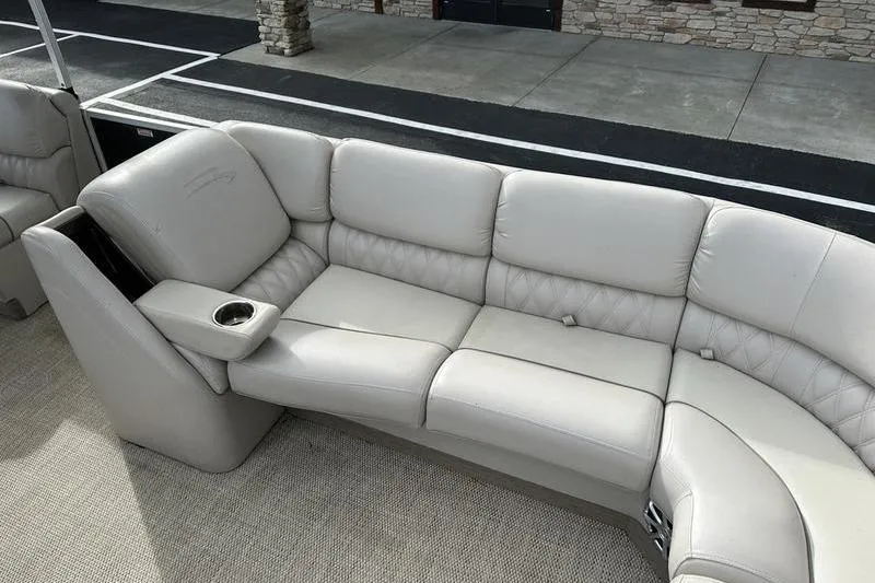 Slide: The Image of 2014 Bennington 2575 RCW boat interior with beige leather seating and cup holder. - 13