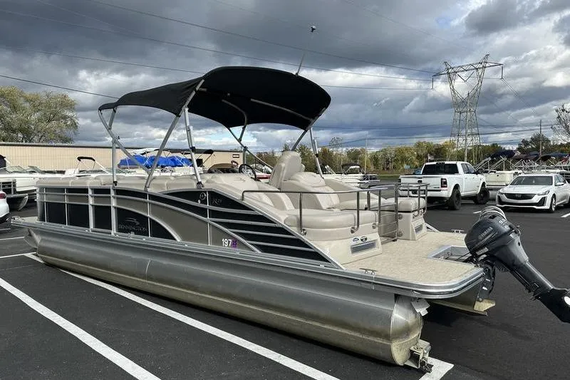 Slide: The Image of 2014 Bennington 2575 RCW pontoon boat displayed indoors at a marine showroom. - 3
