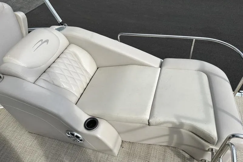 Slide: The Image of 2014 Bennington 2575 RCW boat interior with steering wheel and plush seating. - 7