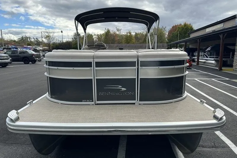 Slide: The Image of Luxurious seating on 2014 Bennington 2575 RCW pontoon boat with beige upholstery and cup holders. - 8