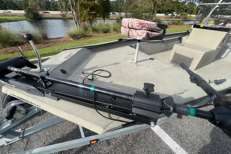 Slide: The Image of 2014 Alumacraft 1756 All Weld MV CC boat on trailer by a lake. - 4