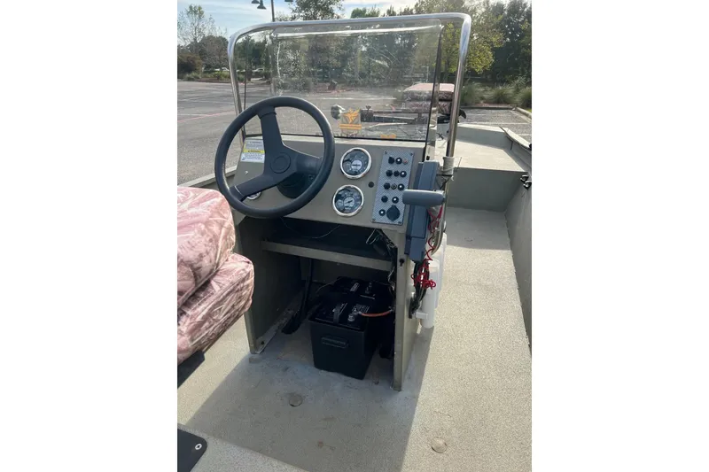 Slide: The Image of 2014 Alumacraft 1756 All Weld MV CC boat console with steering wheel and gauges. - 7