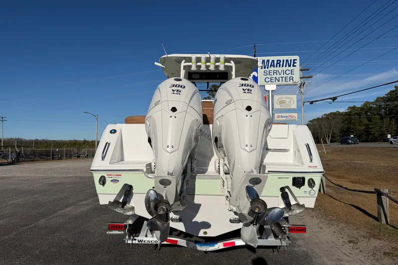 Slide: The Image of 2026 Sea Hunt Ultra 285 Coffin Box boat with twin 300 V6 engines at marine service center. - 10