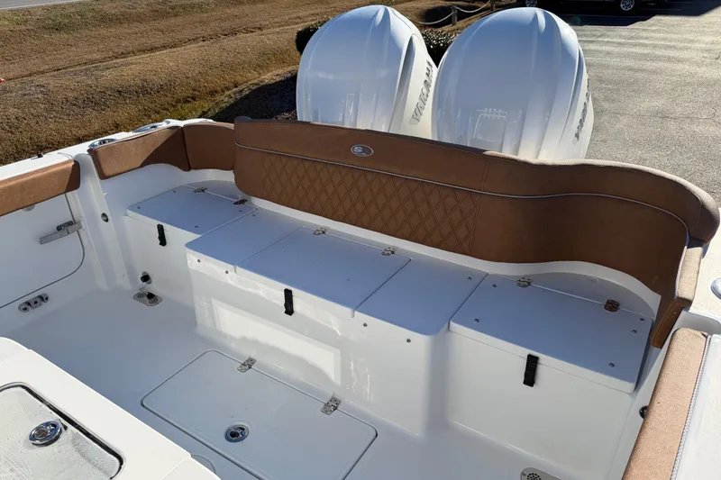 Slide: The Image of 2026 Sea Hunt Ultra 285 Coffin Box boat interior with cushioned seating and storage compartments. - 14