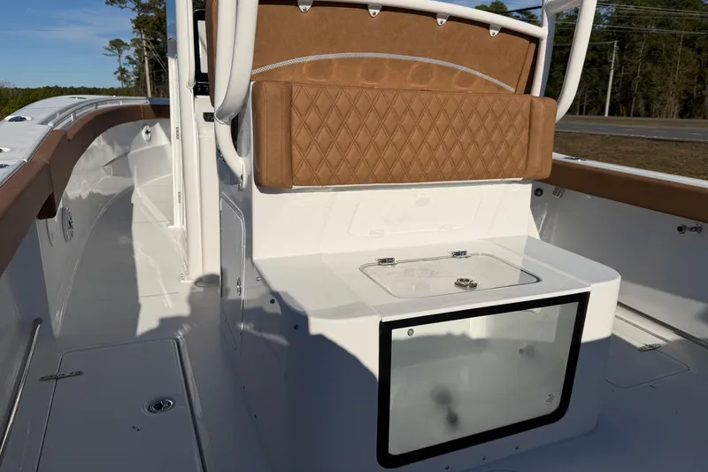 Slide: The Image of 2026 Sea Hunt Ultra 285 Coffin Box boat interior with tan seating and storage. - 15