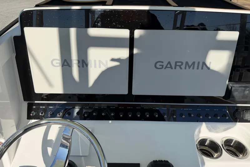 Slide: The Image of 2026 Sea Hunt Ultra 285 Coffin Box dashboard with dual Garmin displays and controls. - 16