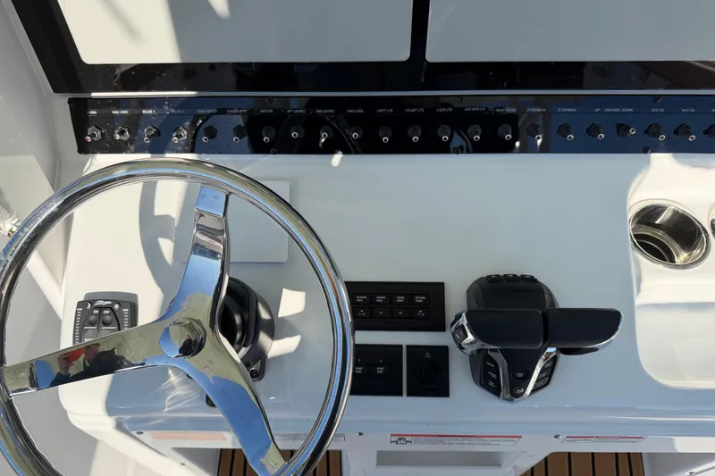 Slide: The Image of Steering console of 2026 Sea Hunt Ultra 285 Coffin Box boat with controls and switches. - 17