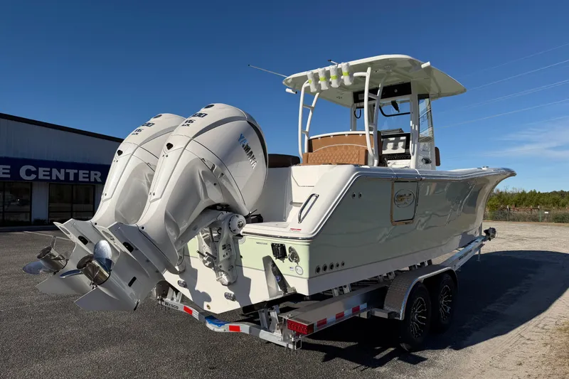 Slide: The Image of 2026 Sea Hunt Ultra 285 Coffin Box boat with dual Yamaha engines on trailer. - 8