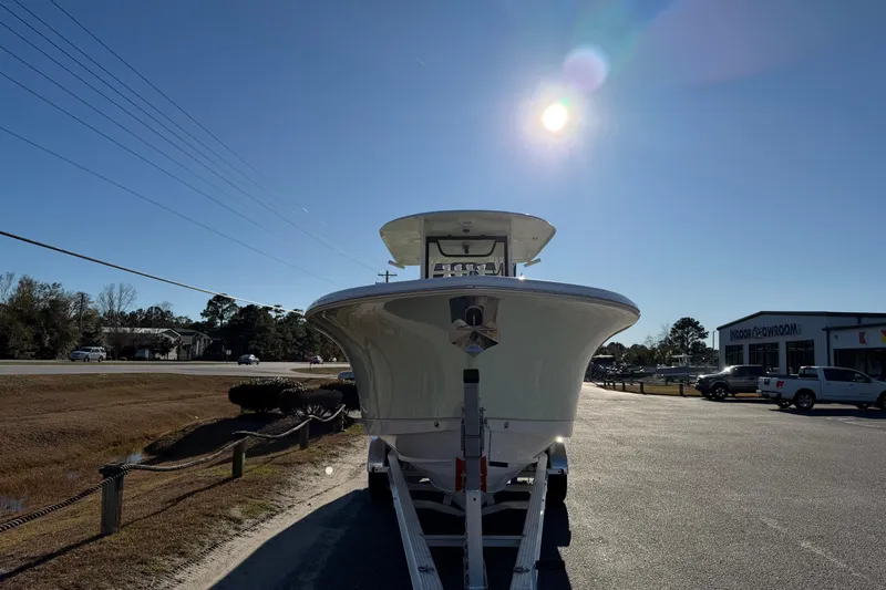 Slide: The Image of 2026 Sea Hunt Ultra 285 Coffin Box boat on trailer under bright sun. - 9
