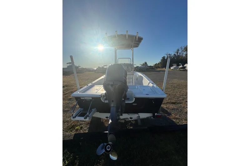 Slide: The Image of 2015 Sportsman Masters 207 Bay Boat with outboard motor, parked under bright sun. - 4