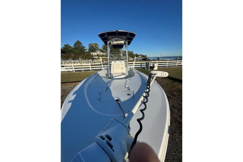Slide: The Image of 2015 Sportsman Masters 207 Bay Boat with trolling motor, parked outdoors. - 7