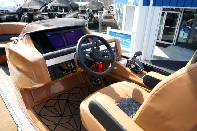 Slide: The Image of 2025 Harris Grand Mariner SL 230 boat interior with modern dashboard and steering wheel. - 10