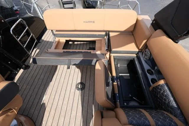 Slide: The Image of 2025 Harris Grand Mariner SL 230 interior with tan seating and storage compartments. - 12