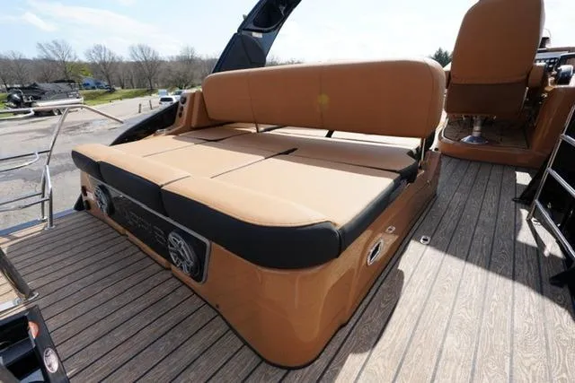 Slide: The Image of 2025 Harris Grand Mariner SL 230 boat with tan seating and deck speakers. - 13