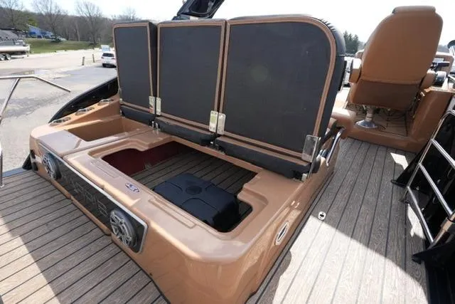 Slide: The Image of 2025 Harris Grand Mariner SL 230 boat with open storage compartment and seating. - 16
