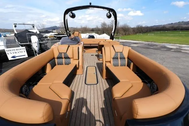 Slide: The Image of 2025 Harris Grand Mariner SL 230 pontoon boat with luxurious tan seating and sleek design. - 6