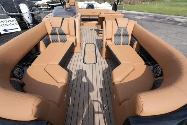 Slide: The Image of 2025 Harris Grand Mariner SL 230 with luxurious tan seating and spacious deck layout. - 7