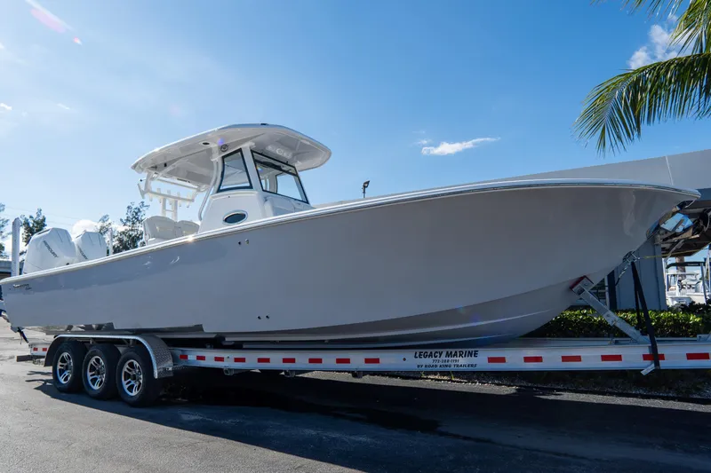 Slide: The Image of 2026 Tidewater 3100 Carolina Bay boat on trailer under clear blue sky. - 1