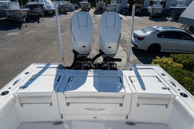 Slide: The Image of 2026 Tidewater 3100 Carolina Bay boat with dual outboard engines in a marina setting. - 12