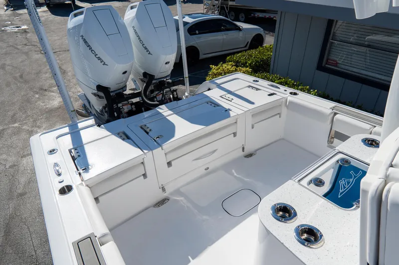 Slide: The Image of 2026 Tidewater 3100 Carolina Bay boat with dual Mercury engines, spacious deck, and modern features. - 13