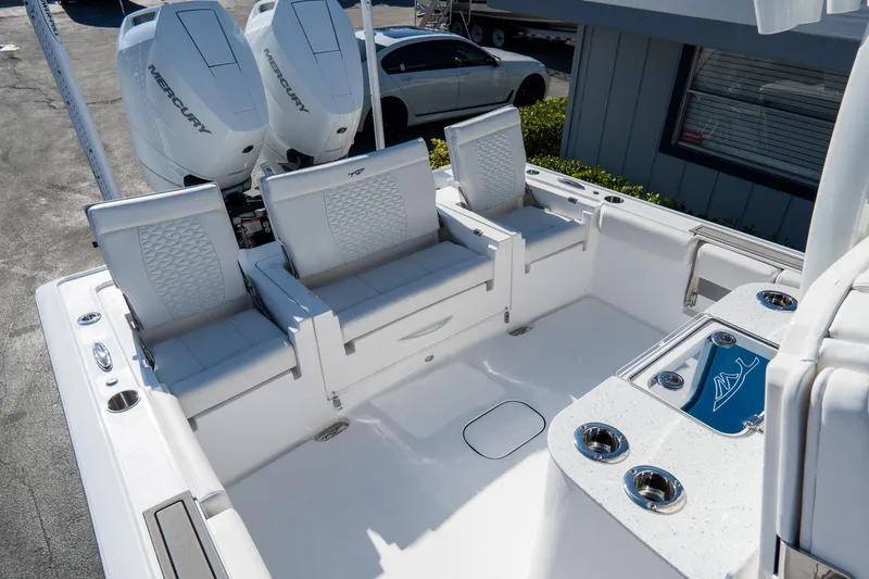 Slide: The Image of 2026 Tidewater 3100 Carolina Bay boat interior with seating and dual Mercury engines. - 14