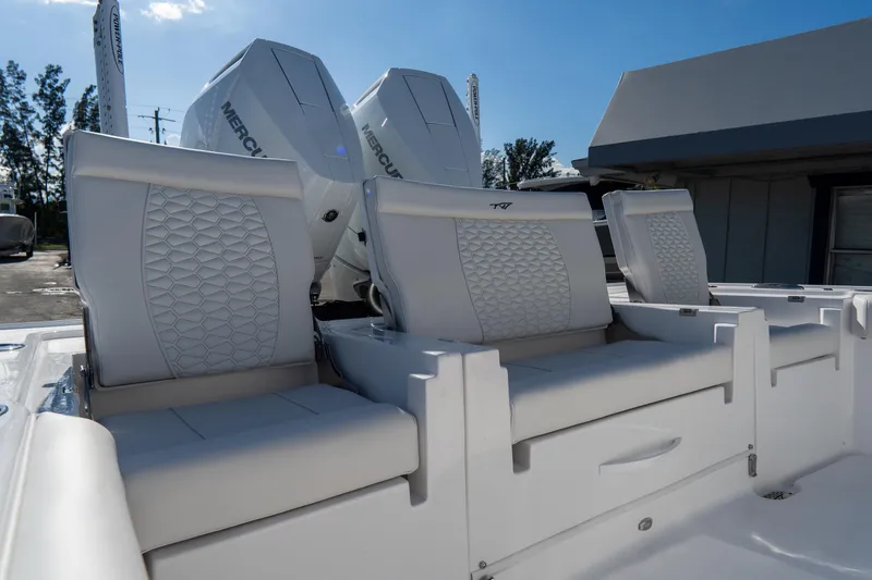Slide: The Image of 2026 Tidewater 3100 Carolina Bay boat seats with dual Mercury engines in the background. - 15