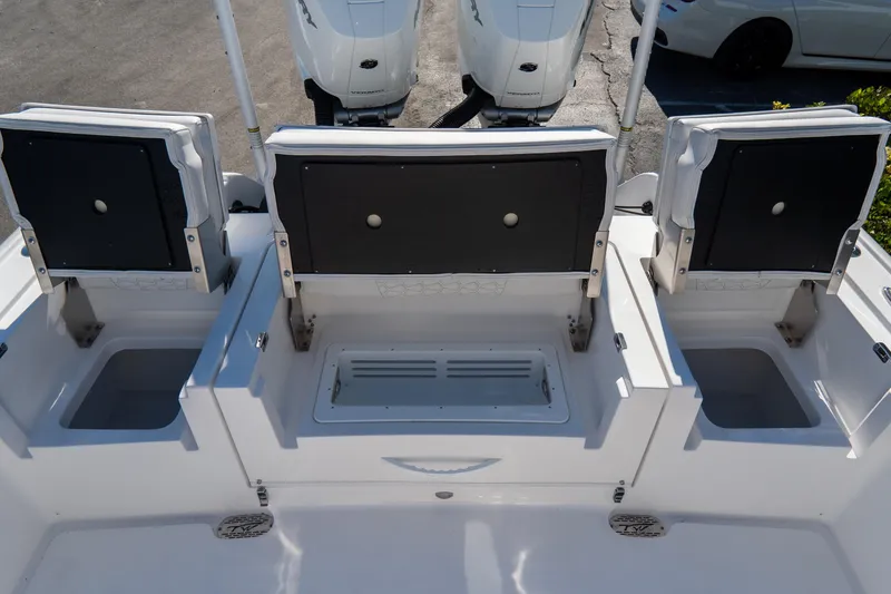 Slide: The Image of 2026 Tidewater 3100 Carolina Bay boat with open storage compartments and dual engines. - 17