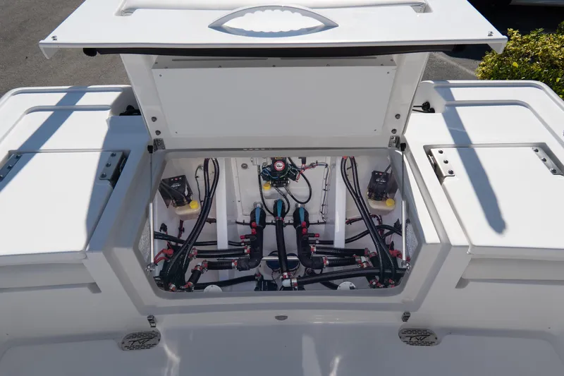 Slide: The Image of 2026 Tidewater 3100 Carolina Bay boat's open hatch showcasing internal wiring and components. - 18