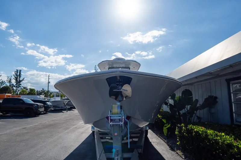Slide: The Image of 2026 Tidewater 3100 Carolina Bay boat on trailer under sunny sky. - 2