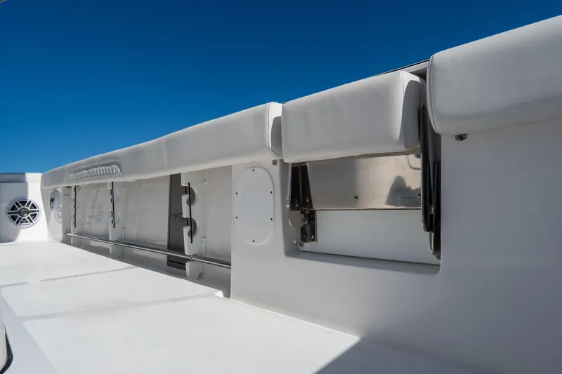 Slide: The Image of 2026 Tidewater 3100 Carolina Bay boat interior with cushioned seating and storage compartments. - 21