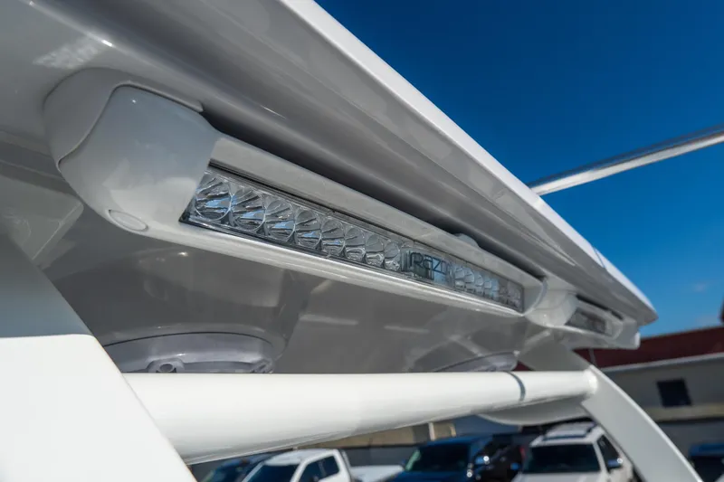 Slide: The Image of Close-up of 2026 Tidewater 3100 Carolina Bay boat's LED light under clear blue sky. - 25