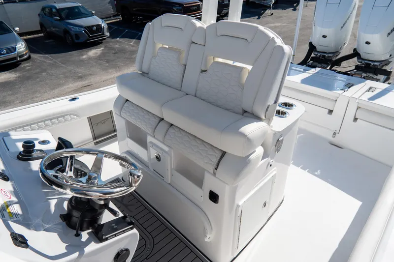 Slide: The Image of 2026 Tidewater 3100 Carolina Bay boat interior with dual helm seats and steering wheel. - 27