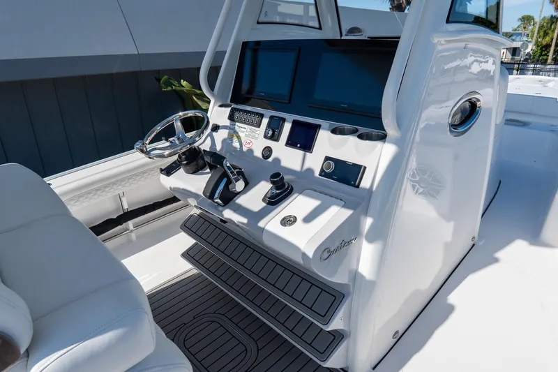 Slide: The Image of 2026 Tidewater 3100 Carolina Bay boat console with modern controls and displays. - 30