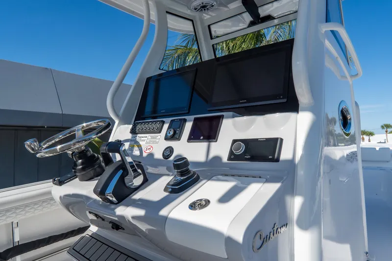 Slide: The Image of Control panel of 2026 Tidewater 3100 Carolina Bay boat with steering wheel and displays. - 31