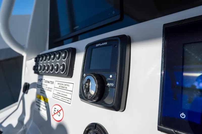 Slide: The Image of Control panel of 2026 Tidewater 3100 Carolina Bay boat with digital display and buttons. - 34
