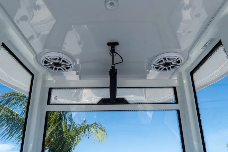 Slide: The Image of Interior view of 2026 Tidewater 3100 Carolina Bay boat with speakers and palm tree outside. - 36