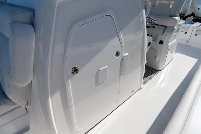 Slide: The Image of 2026 Tidewater 3100 Carolina Bay boat interior with sleek white design and seating. - 37