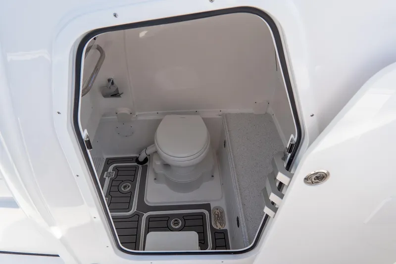 Slide: The Image of 2026 Tidewater 3100 Carolina Bay boat interior with compact marine toilet. - 38