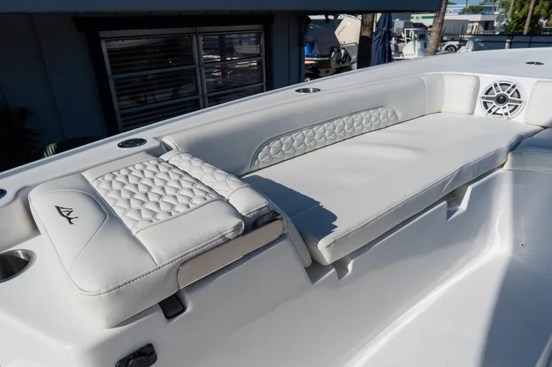 Slide: The Image of 2026 Tidewater 3100 Carolina Bay boat with luxurious white seating and speaker system. - 55