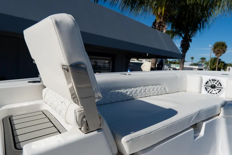 Slide: The Image of 2026 Tidewater 3100 Carolina Bay boat with white cushioned seating and speaker. - 57