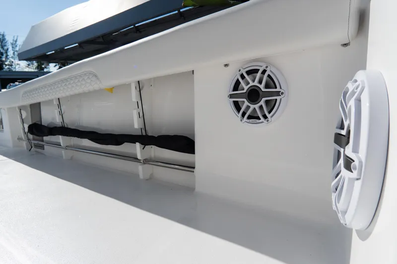 Slide: The Image of 2026 Tidewater 3100 Carolina Bay boat interior with speakers and storage compartment. - 58
