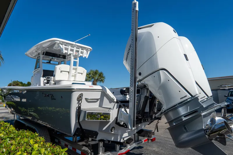 Slide: The Image of 2026 Tidewater 3100 Carolina Bay boat with dual outboard motors on a trailer. - 6