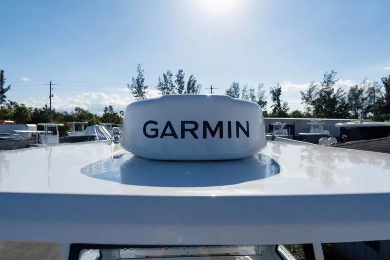 Slide: The Image of Tidewater 3100 Carolina Bay 2026 boat with Garmin radar under clear blue sky. - 60