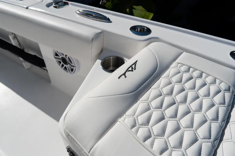 Slide: The Image of Luxurious seating on 2026 Tidewater 3100 Carolina Bay boat with stylish stitching and cup holder. - 61