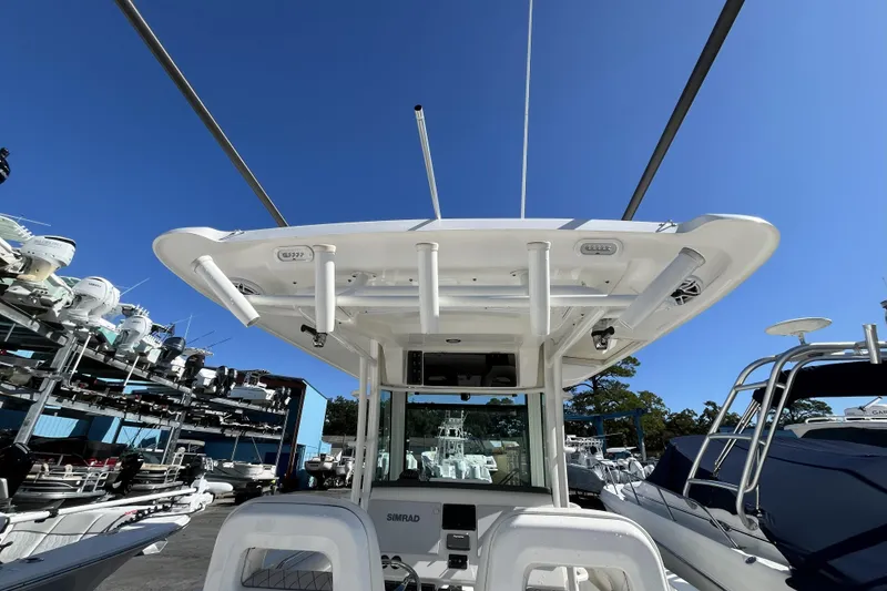 Slide: The Image of 2012 Boston Whaler 320 Outrage boat, featuring a sleek design and advanced navigation equipment. - 11