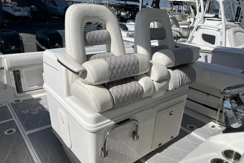 Slide: The Image of Luxury seating on a 2012 Boston Whaler 320 Outrage boat, featuring quilted upholstery. - 12