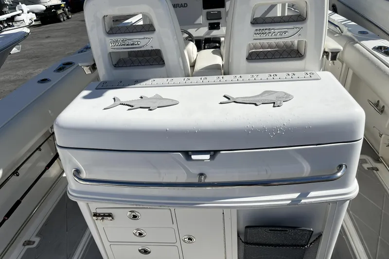 Slide: The Image of 2012 Boston Whaler 320 Outrage boat interior with fishing station and measuring guide. - 14