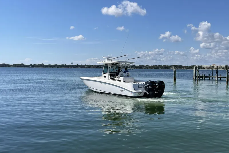 Slide: The Image of 2012 Boston Whaler 320 Outrage boat cruising on a calm, sunny lake. - 3