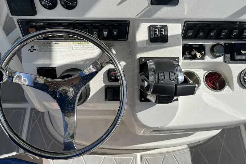 Slide: The Image of Steering console of a 2012 Boston Whaler 320 Outrage boat, featuring controls and gauges. - 7